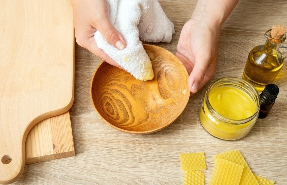 Create a natural wood polish with olive oil, beeswax, and essential oils to restore shine and nourish your wooden surfaces.