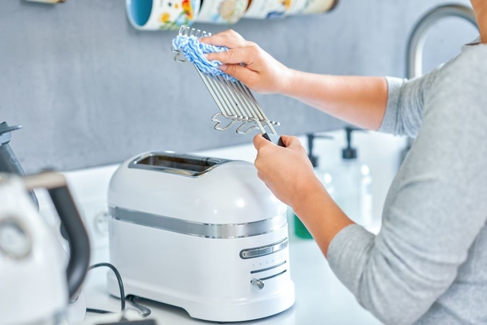 Removing and thoroughly cleaning the toaster racks helps prevent buildup of crumbs and grease, ensuring even toasting and preventing potential fire hazards.