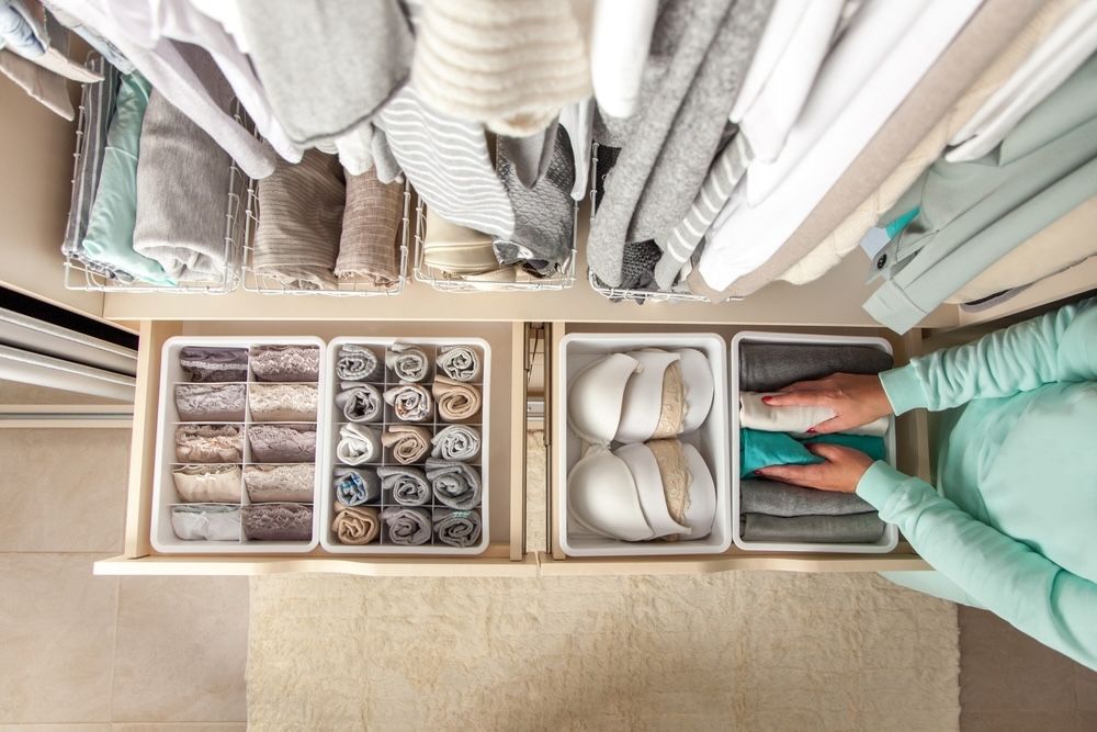 Fold clothes neatly and store them upright for maximum visibility and access.