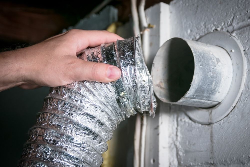 Use appropriate tools to safely detach the vent hose from the dryer.