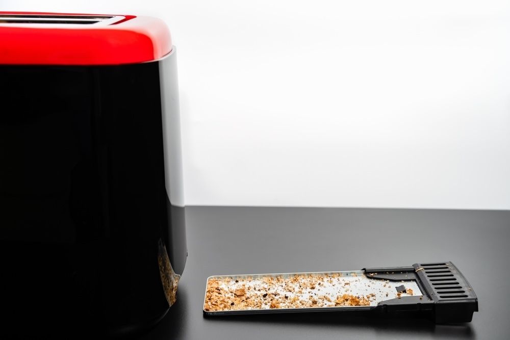 Emptying the crumb tray regularly is a simple yet effective way to prevent crumbs from burning inside the toaster, ensuring a longer lifespan for your appliance.