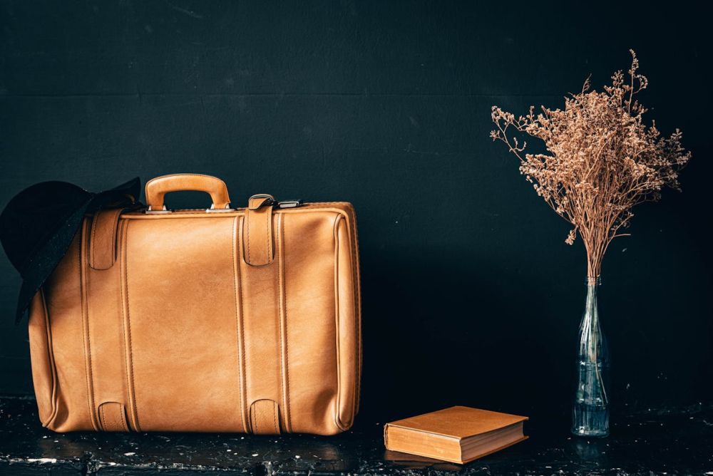 Leather suitcases against the black background.