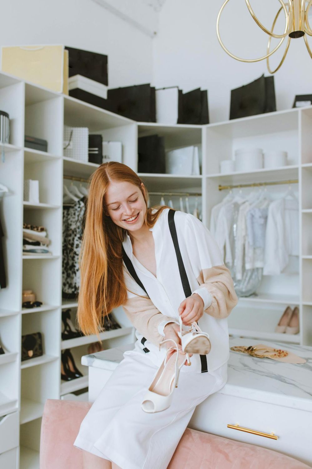 Young woman picking shoes in the cabinet.