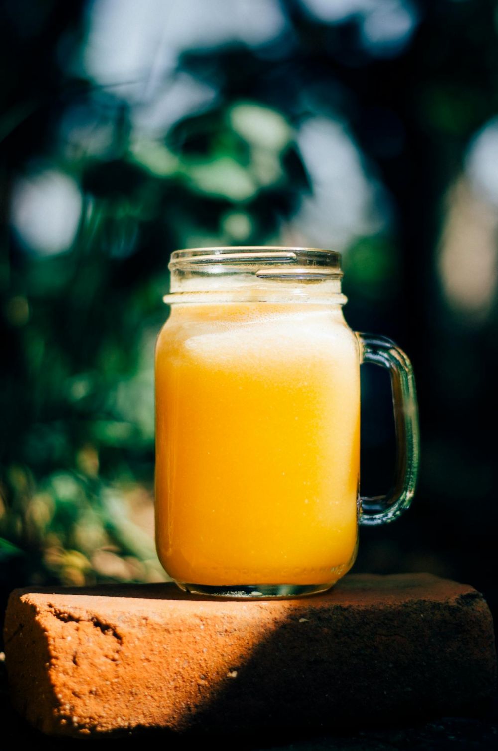 Fruits orange juice in mason-jar.