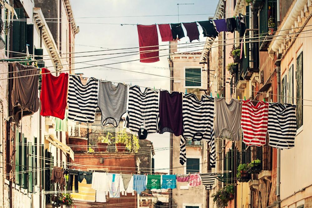 Washing the clothes and drying in the sunlight.