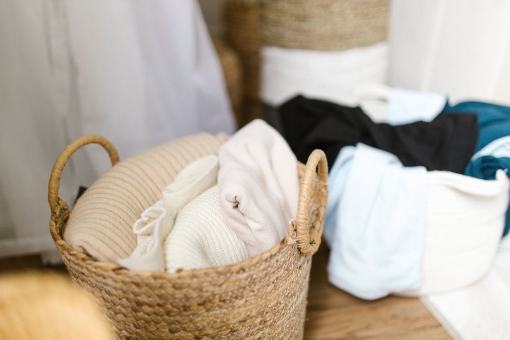 Laundry basket with a clothes in it.