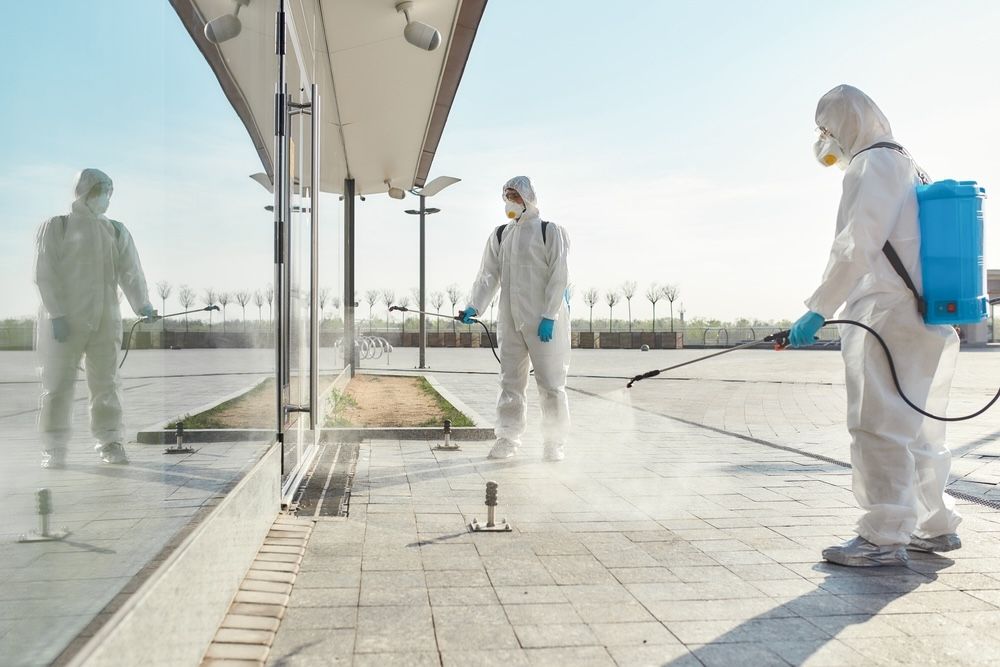 Sanitizing public areas with electrostatic sprayers for widespread protection.