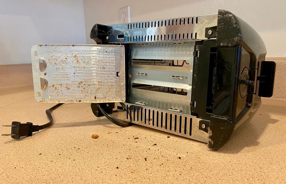 Shaking out loose crumbs is an easy yet crucial step in maintaining your toaster. It helps prevent uneven toasting and potential fire hazards.