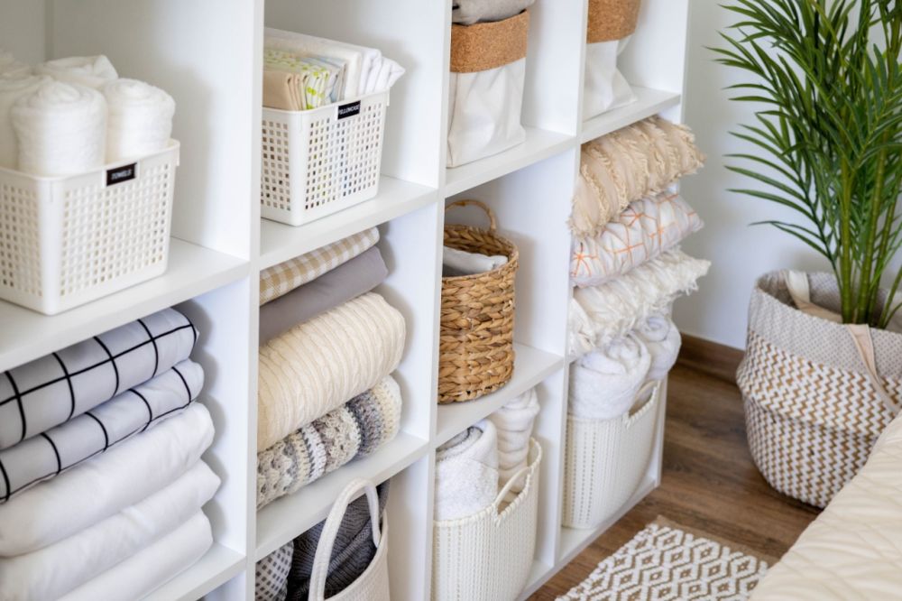 Neatly folded linens and organized baskets highlight the advantages of hiring cleaning experts.