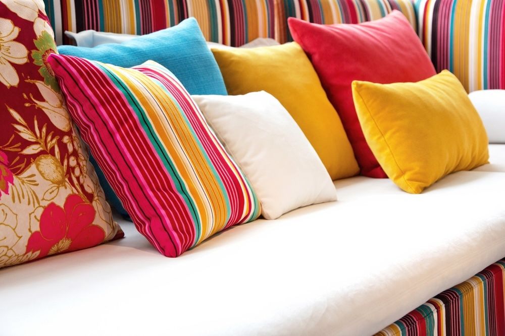 Brightly colored cushions in various textures can transform any seating area into a cozy haven.