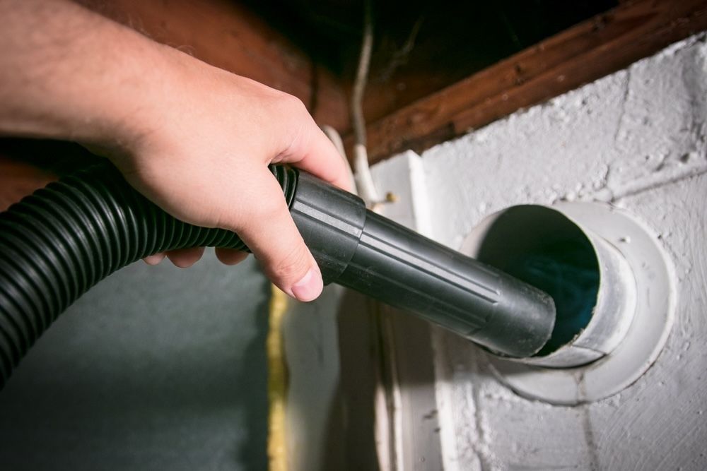 Use a vacuum with a hose attachment to remove lint and debris from the vent.