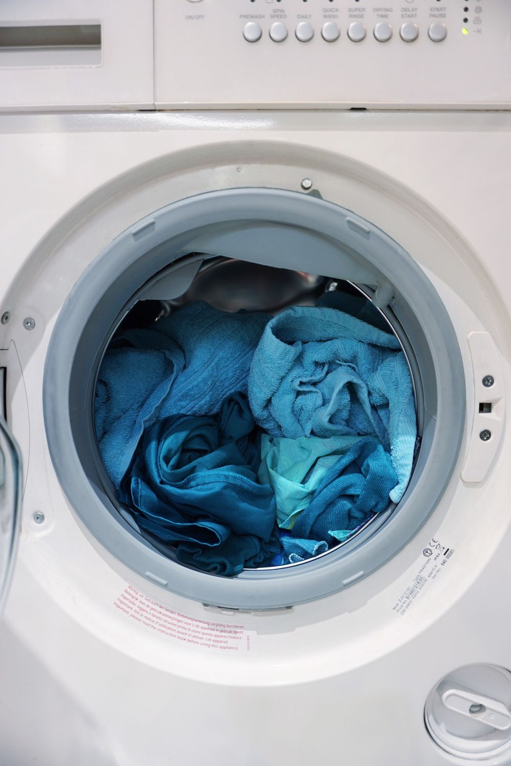 A washing machine tub full of clothes.