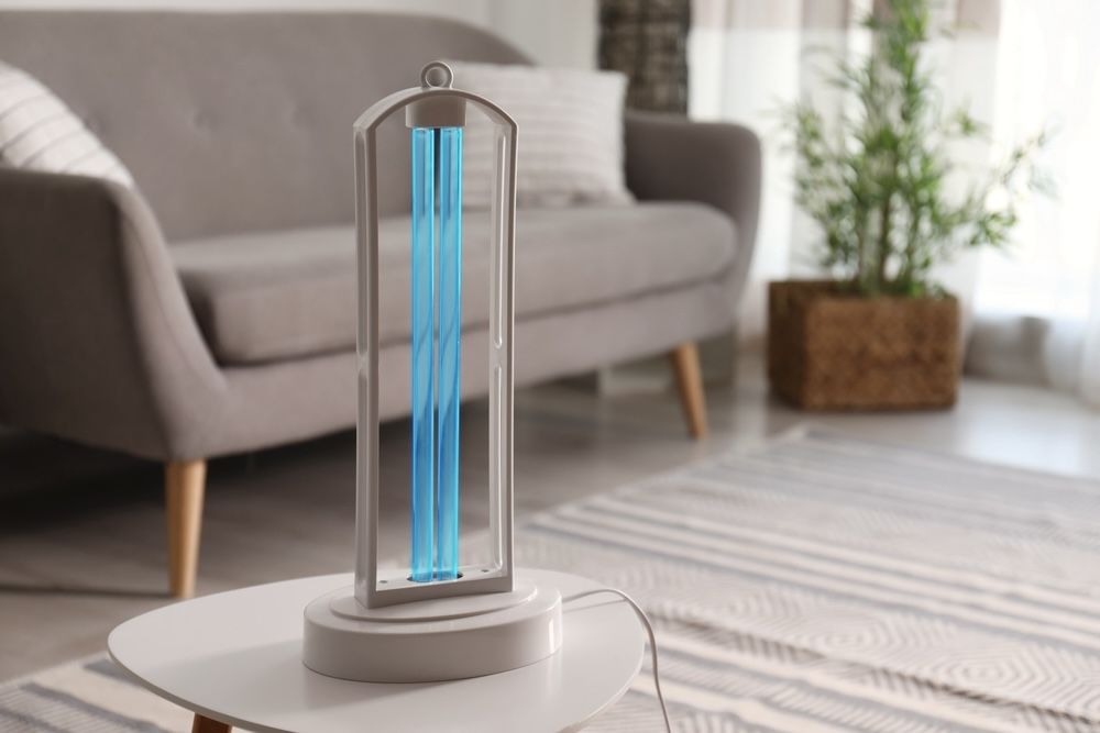 A UV-C lamp sits on a table in a living room, demonstrating how residential settings can benefit from this technology. These lamps are designed to sanitize air and surfaces, providing a safer, healthier living environment.