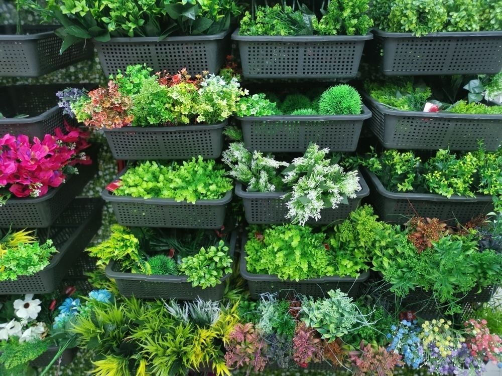 Container stacking involves arranging pots or containers in a tiered fashion to create a cascading effect of greenery. This method is perfect for maximizing vertical space in small gardens, providing an attractive and practical solution for growing a variety of plants.