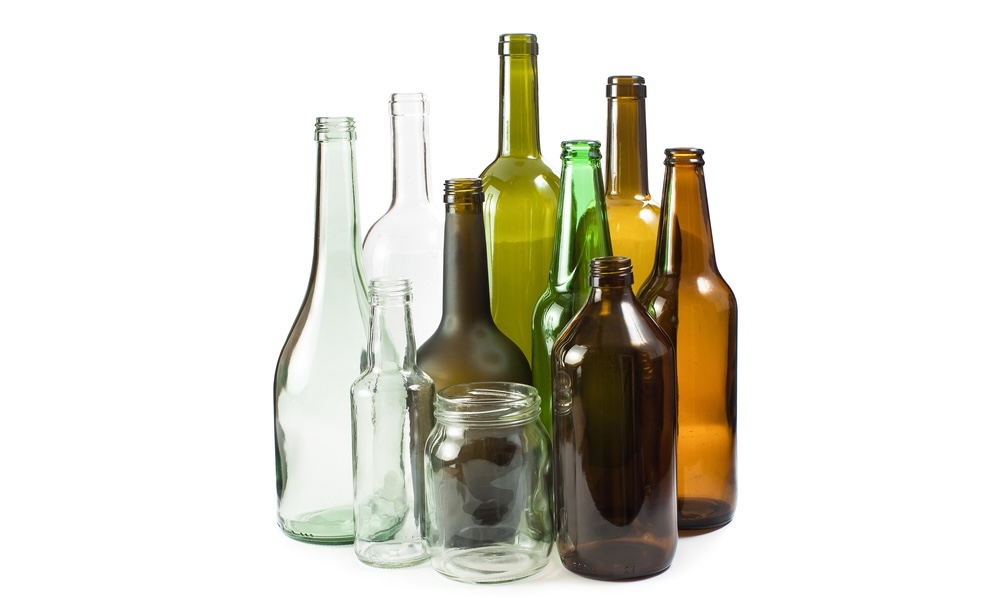 A transparent view of recyclable glass bottles in various shapes and colors.