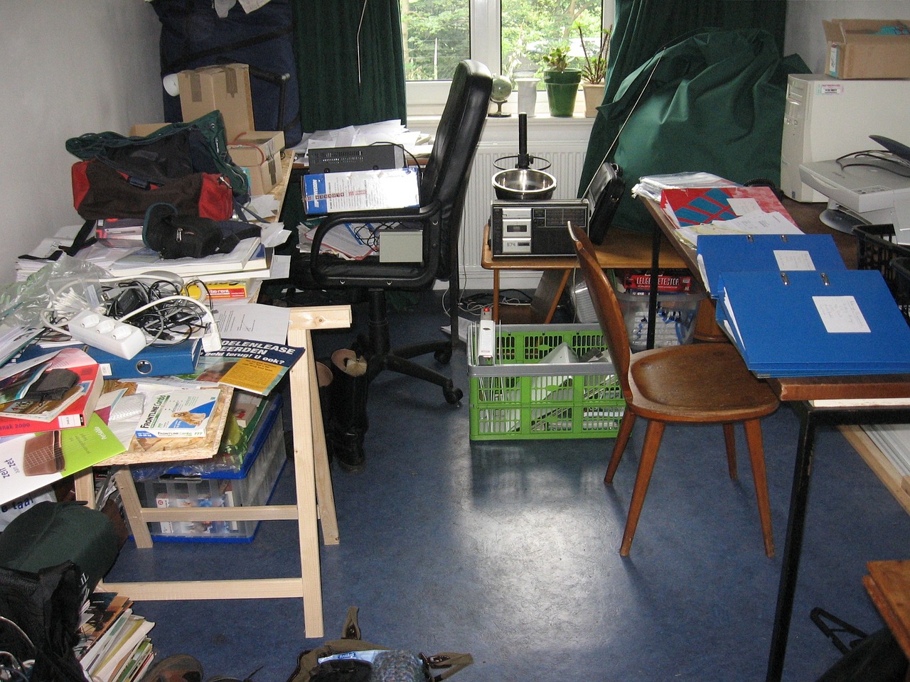 Clutter Chaos: Cluttered desks overwhelmed with papers, gadgets, and miscellaneous items.