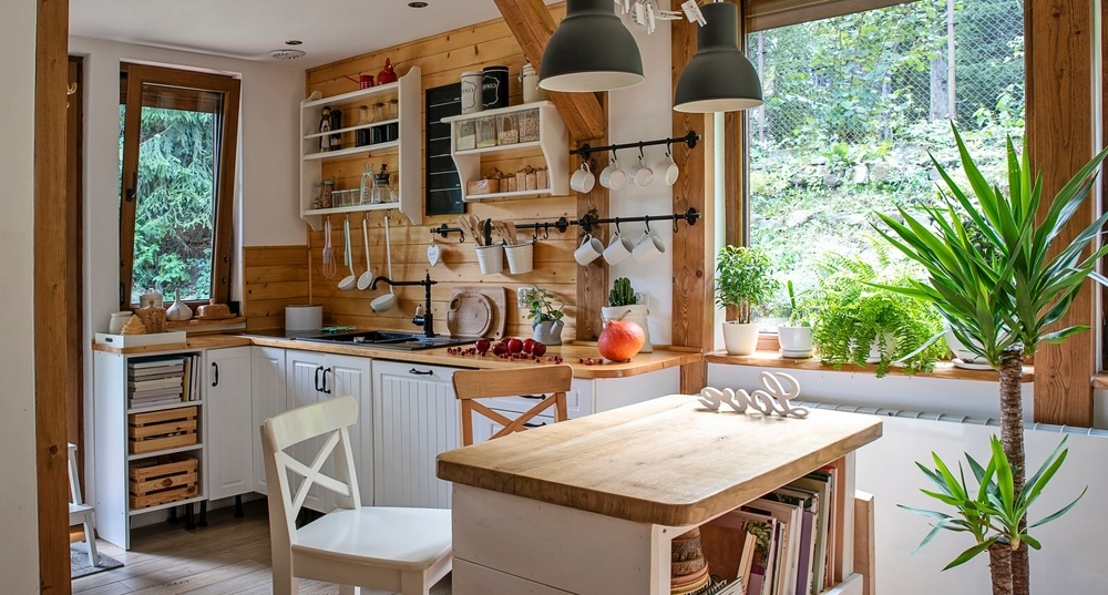 Homespun Rustic Kitchen - This photo presents a charming kitchen corner, radiating rustic warmth with its wooden wall panels and open shelving. A butcher-block island and white cabinetry add functionality to this quaint and inviting culinary retreat.